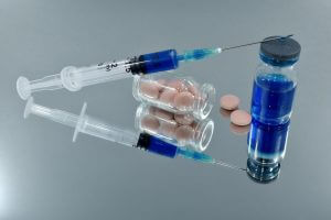 带有一些药丸的 COVID 疫苗的图像